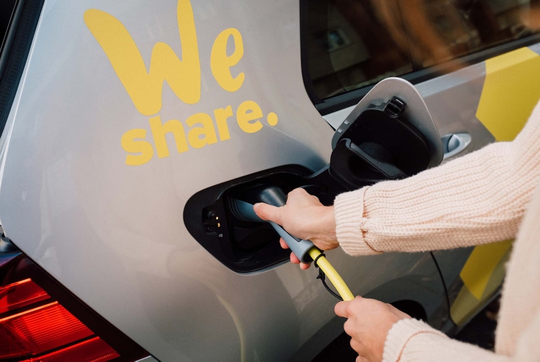 Photo: we-share.io, 100% elektrical carsharing. Someone charging and electric car.