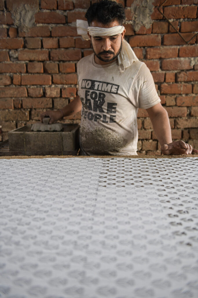 Artisans showcase their expertise in traditional  Bagru and Dabu block printing in India; designs are meticulously applied with mud and inks onto fabric. Each artisan demonstrates a unique process phase, from aligning patterns to ensuring precision in every print. Their dedication and skill preserve this ancient art form, creating beautiful textiles celebrating India's rich cultural heritage. Photo Lizane Louw