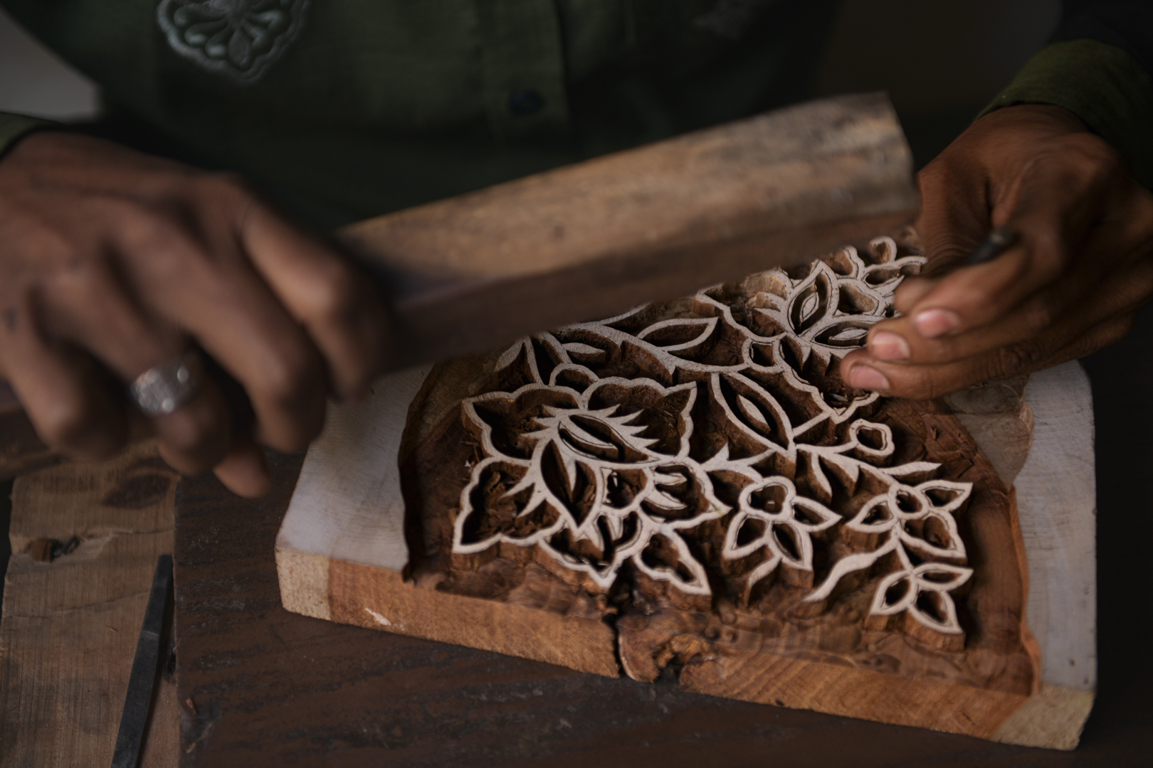 An artisan carves an intricate floral pattern into a wooden block, an essential tool in India's traditional block printing process. The craftsmanship and precision required to create these blocks are evident as he carefully chisels each design to ensure perfect prints. This is where artistry meets the skill needed to produce the beautiful, detailed patterns that adorn the block-printed fabrics of the region. Photo Lizane Louw