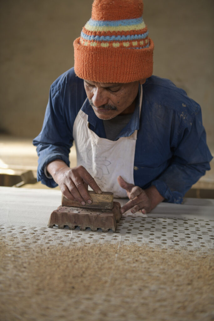 Artisans showcase their expertise in traditional  Bagru and Dabu block printing in India; designs are meticulously applied with mud and inks onto fabric. Each artisan demonstrates a unique process phase, from aligning patterns to ensuring precision in every print. Their dedication and skill preserve this ancient art form, creating beautiful textiles celebrating India's rich cultural heritage. Photo Lizane Louw